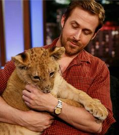 a man holding a small animal on his lap