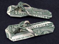 two pieces of money tied together on a black surface with the words america written on them