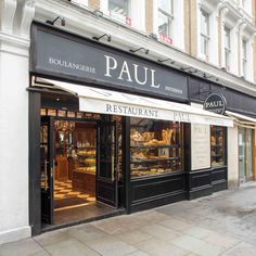 a restaurant called paul on the corner of a street in front of a storefront