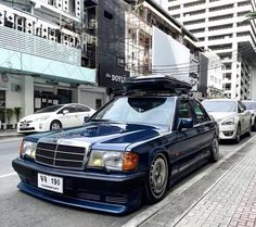 a blue car parked on the side of a street