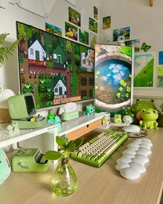 there is a computer on the desk with green decorations