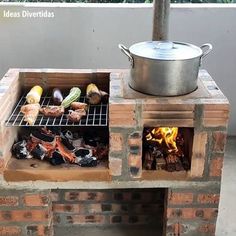 an outdoor grill made out of bricks with food cooking on it and a pot over the fire