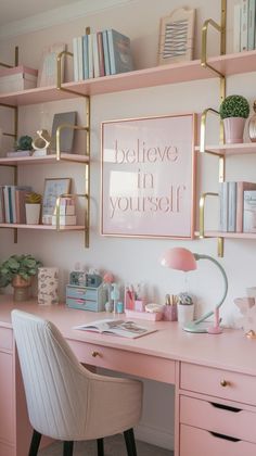 a pink desk topped with lots of shelves filled with books and office supplies next to a white chair