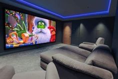 a home theater with two recliners and a large screen