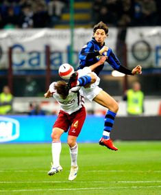 two soccer players jump for the ball during a game