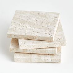 four pieces of white marble stacked on top of each other