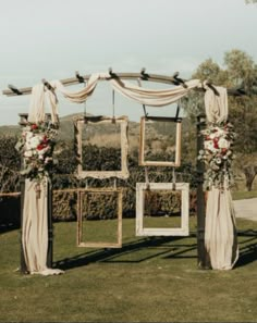 an outdoor wedding setup with white drapes and flowers