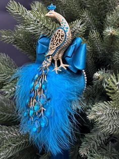 a blue ornament with a peacock on it's back and feathers around the neck