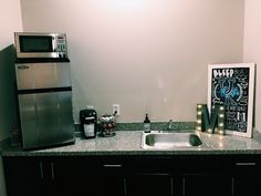 a kitchen counter with a sink and refrigerator