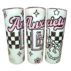 three shot glasses with designs on them sitting next to each other