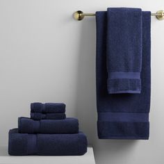 the towels are lined up on the shelf next to the towel rack