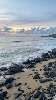 the beach is lined with rocks and water