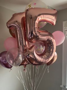 a bunch of balloons that are shaped like the number five