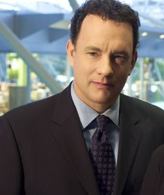 a man in a suit and tie looking at the camera