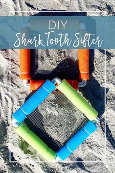 an overhead view of a toy shark in the sand with text overlay that reads diy shark tooth sitter