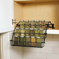 an organized spice rack in the corner of a kitchen cabinet with spices and seasonings on it