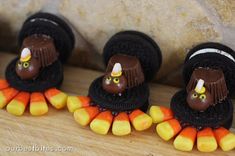 three little turkeys are sitting on top of each other with candy in their mouths