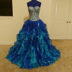 Blue Quinceera Formal Gown, Only Been Worn Once. Embellished Boned- Corset Bodice With Lace Back Ties. Ruffled, Full-Volume Skirt Large Enough To Wear With Hoop Skirt Or Petticoat. Sure To Be A Glamourous Show-Stopper At Any Formal Event. Size 4, Outer Shell: 100% Polyester Inner Shell: 100% Nylon Glamorous Fitted Blue Ball Gown, Glamorous Blue Ball Gown For Prom, Glamorous Blue Ball Gown For Wedding, Blue Organza Dress For Prom Season, Blue Fitted Glamorous Ball Gown, Embellished Royal Blue Evening Dress For Wedding, Blue Organza Evening Dress For Prom Season, Blue Sequined Evening Dress For Wedding, Fitted Blue Ball Gown