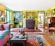 a living room filled with furniture and colorful rugs