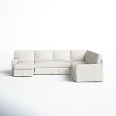 a white sectional couch sitting on top of a white floor