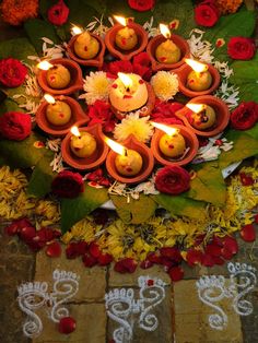 a bunch of candles that are in the middle of some flowers and leaves with numbers written on it