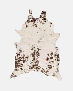 a brown and white cowhide rug with spots on it's back, against a white background