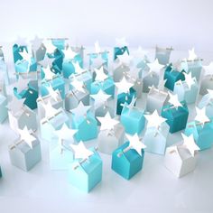 many blue and white boxes with stars on them are arranged in the shape of cubes