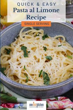 a bowl filled with pasta and parmesan on top of a floral table cloth