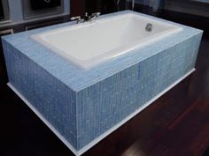 a bath tub sitting on top of a wooden floor