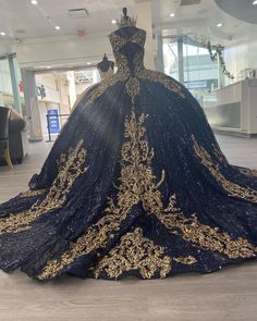 a black and gold dress on display in a store