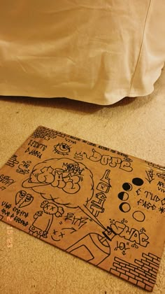 a drawing on the floor next to a bed