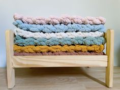 a stack of towels sitting on top of a wooden chair