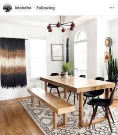 a dining room table with two benches in front of it