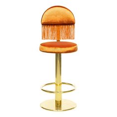 an orange stool with a gold base and fringed foot rests on a white background