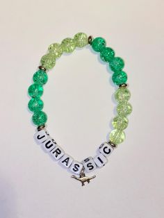 Jurassic Glass Bead green Bracelet - Jurassic with a Dinosaur charm inspired from the movie  8" Handcrafted with love Green Bracelet, A Dinosaur, Green Bead, Glass Bead, The Movie, With Love, Beauty Book, Glass Beads, Jewelry Bracelets