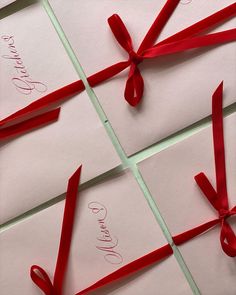 four cards with red ribbon tied around them and the word love is written on each card