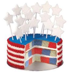 a patriotic cake with white stars on top and red, white, and blue icing