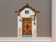 a wooden door is painted white and blue with an intricate design on the front side