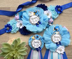 three blue and white ribbons with flowers on them