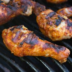 some chicken wings are cooking on a grill