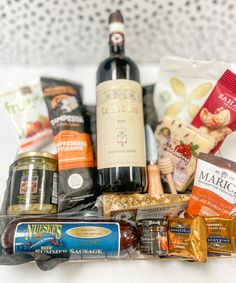 an assortment of food and wine in a basket