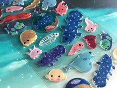 there are many different sea animals on the glass table and one is blue with white dots