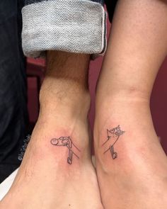 two people with matching tattoos on their feet, one has a cat and the other has a dog