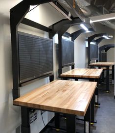 the tables are lined up against the wall in the room with no one around them