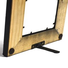 an old wooden frame with black handles on a white background, showing the bottom part of the frame