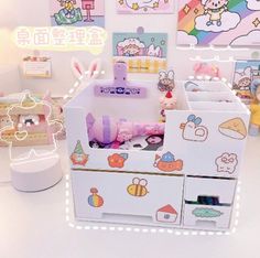 an assortment of toys are on display in a toy room with hello kitty wallpaper