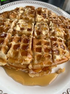 waffles on a plate with syrup drizzled over them