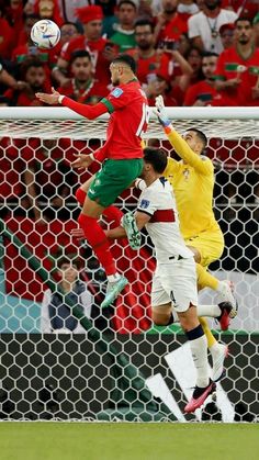 two soccer players jump to head the ball