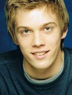 a young man with blonde hair and blue eyes