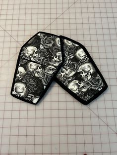 two pieces of cloth with skulls and roses on them